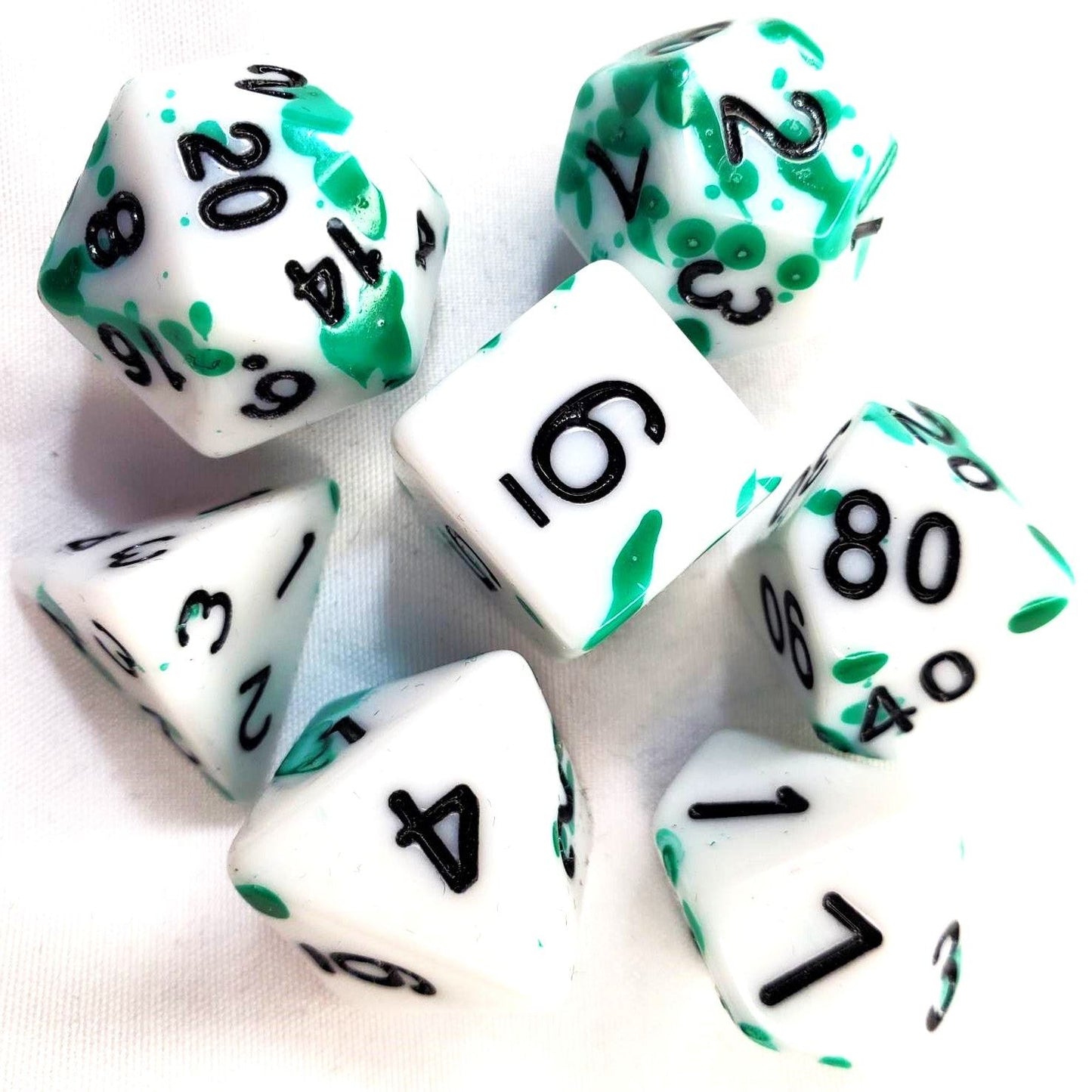 White Acrylic Dice Set with Green Splatter and Black Numbering
